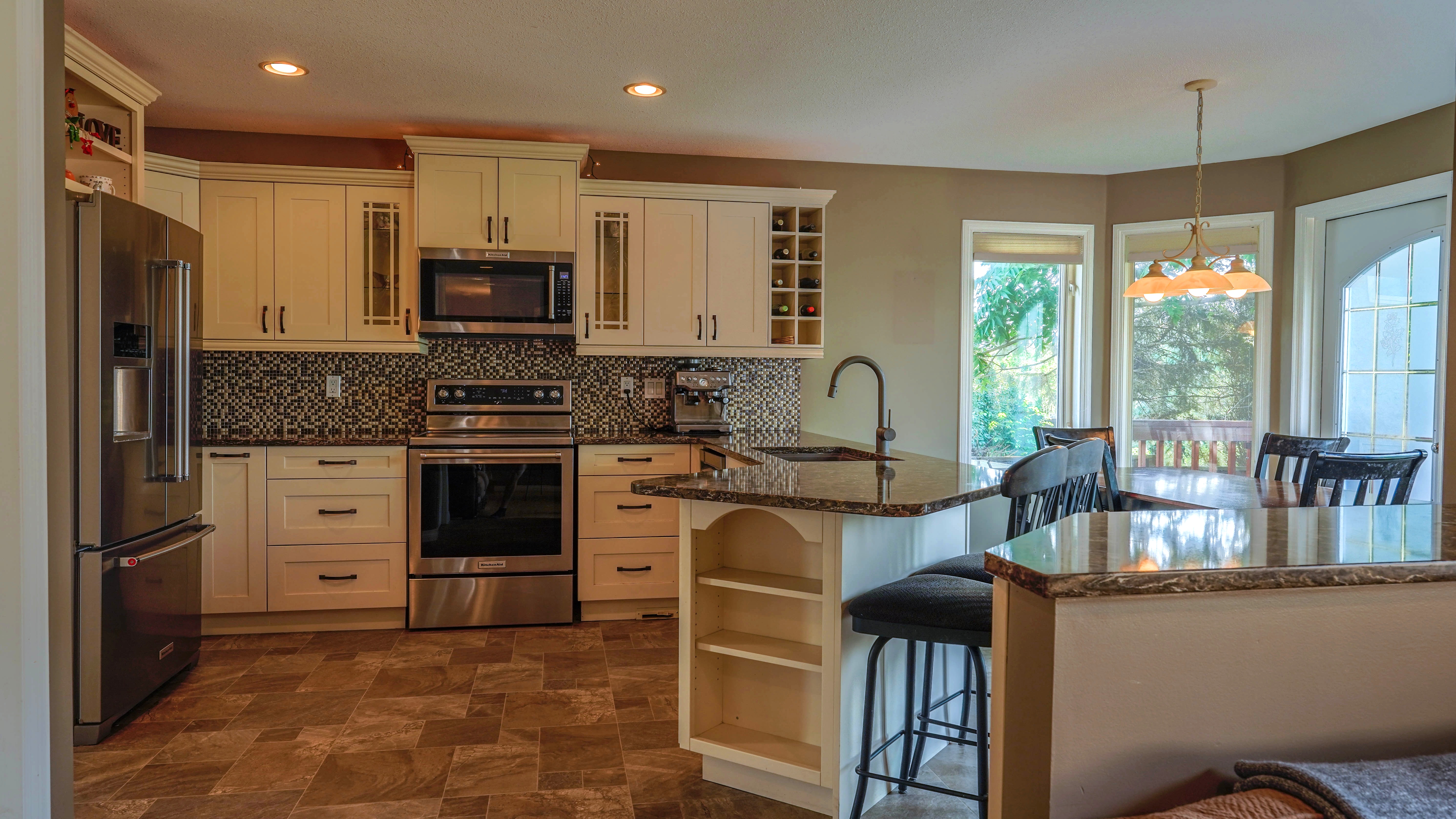 Kitchen with white cabinets, granite, and stainless appliances
