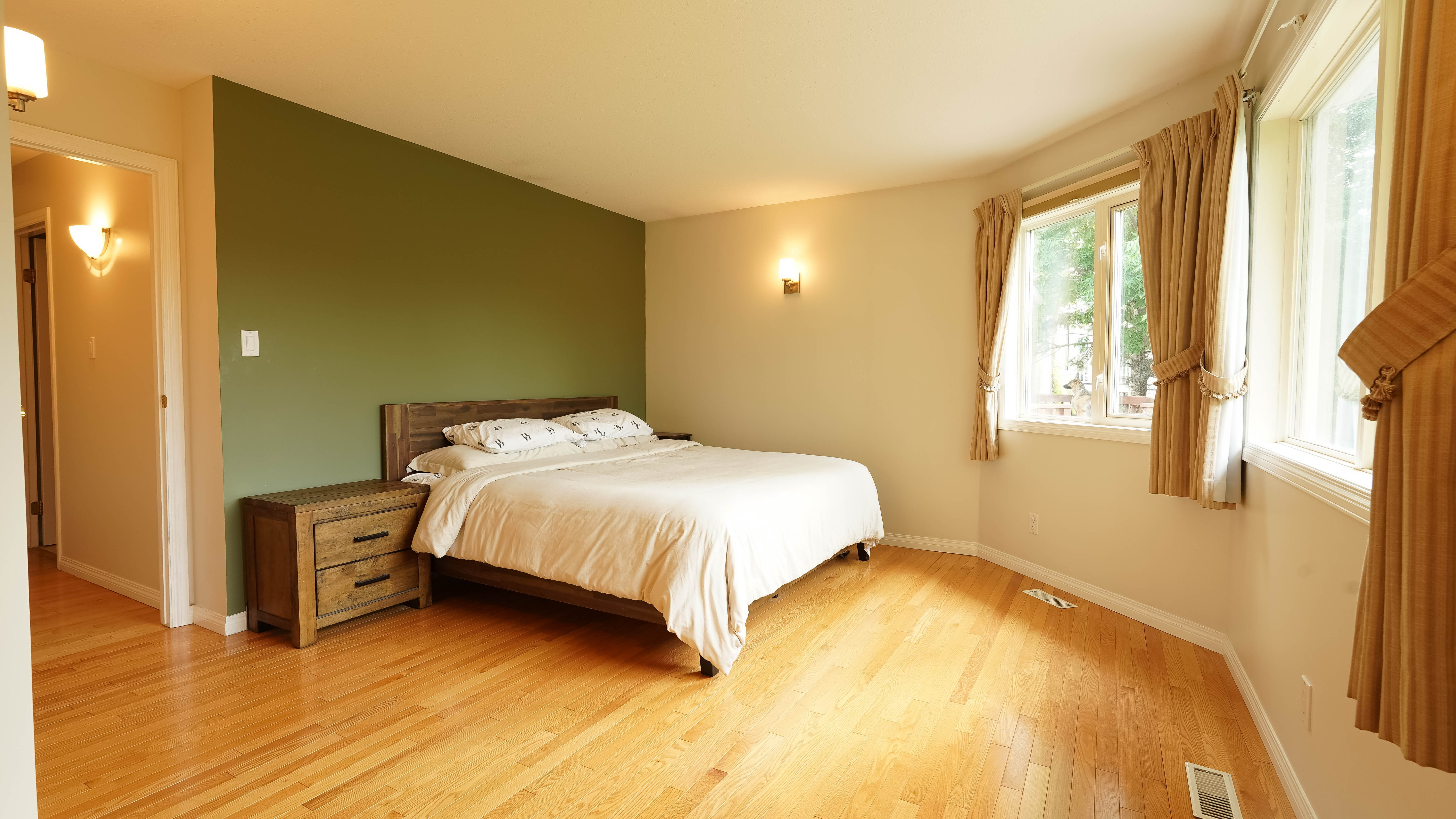 Spacious primary bedroom with greenspace views